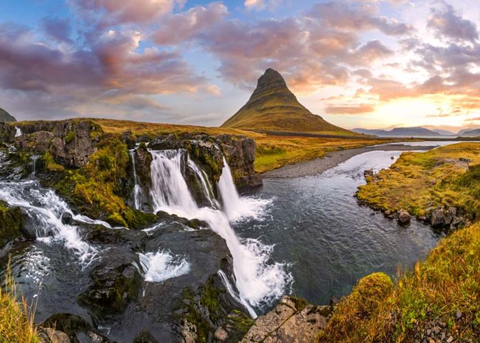 A beautiful waterfall in Iceland with vibrant green moss