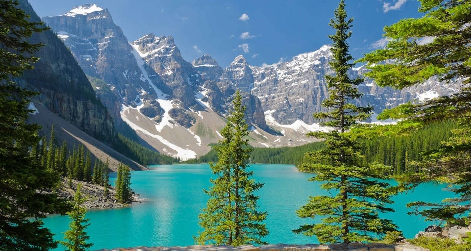Turquoise lake surrounded by tall, snow-capped peaks in the Canadian Rockies